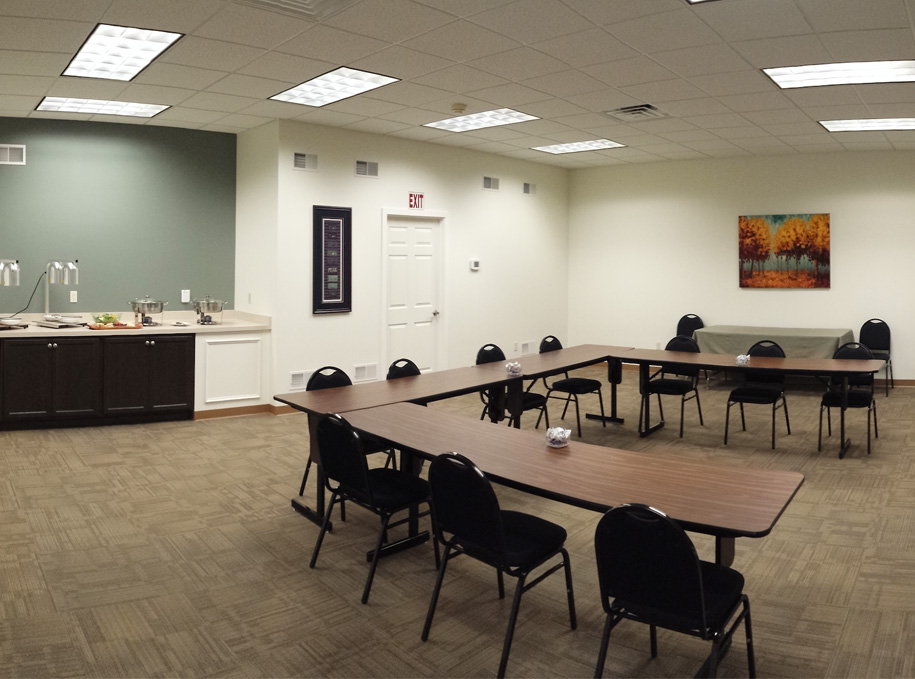 a white conference room with tables and chairs